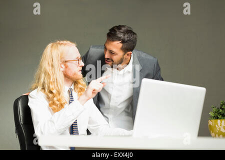 Businessmen talking in office Stock Photo