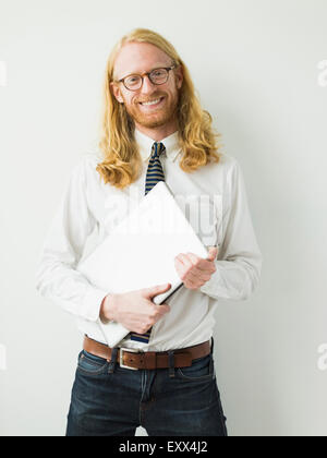 Portrait of smiling man with laptop Stock Photo