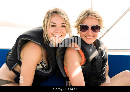 Two young women wearing life jackets Stock Photo
