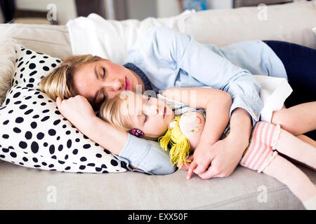 Mother and daughter (2-3) sleeping on sofa Stock Photo
