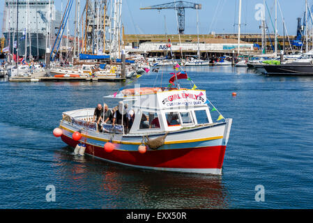 Boat trip returning to the harbour, Custom House Quay, Falmouth, Cornwall, England, UK Stock Photo