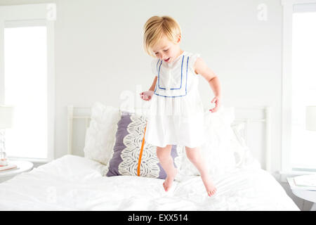 Girl (2-3) jumping on bed Stock Photo