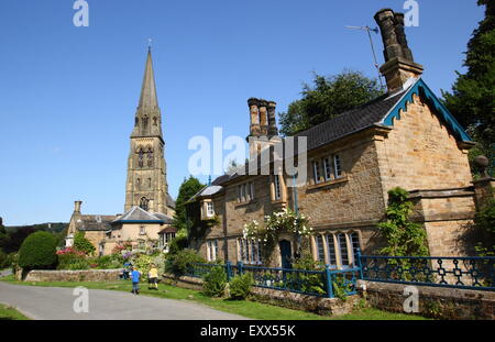 The spire of st. Peter's Church rise above Edensor villlage on the Chatsworth Estate, Derbyshire England UK Stock Photo