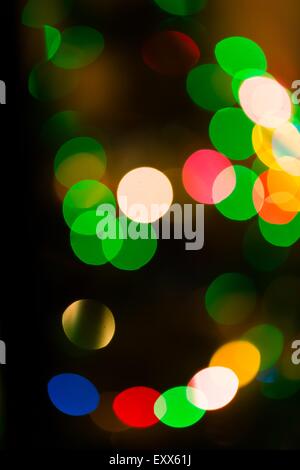 Christmas Bokeh background. Defocused colorful abstraction of lights on christmas tree Stock Photo