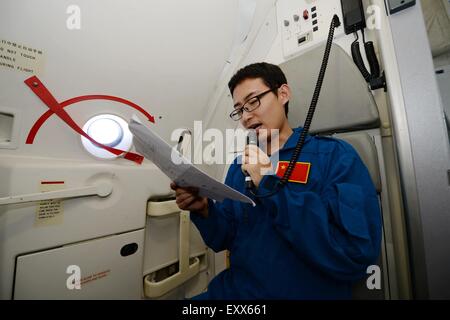 (150717) -- XI'AN, July 17, 2015 (Xinhua) -- Engineer Jin Xing introduces the ARJ21-700 jet to passengers during a demonstration flight in Xi'an, capital city of northwest China's Shaanxi Province, July 17, 2015. The ARJ21, short for Advanced Regional Jet for the 21st Century, is a type of regional airliner designed and manufactured by the Commercial Aircraft Corporation of China (COMAC). Over twenty representatives were invited on Friday to experience the one-hour demonstration flight and give feedbacks so as to help improve the overall performance of the jet. (Xinhua/Li Yibo) (mp) Stock Photo