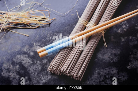 Japanese Soba noodles on a vintage wooden background with the chop sticks Stock Photo