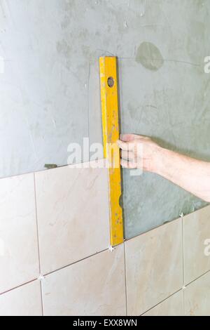 Hand of worker with spirit level. repair, building, technology and home concept Stock Photo