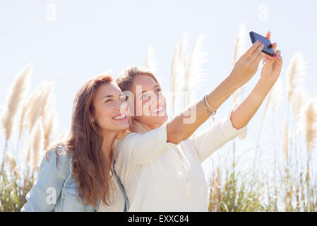 Friends pausing for selfie during road trip Stock Photo