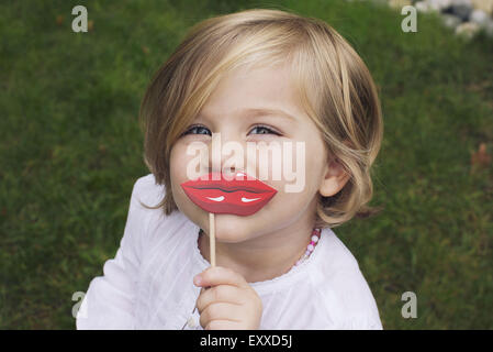 Little girl wearing costume lips Stock Photo