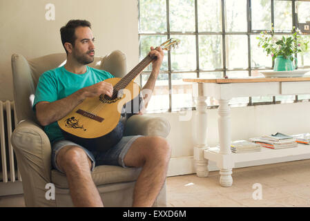 Man playing acoustic guitar Stock Photo