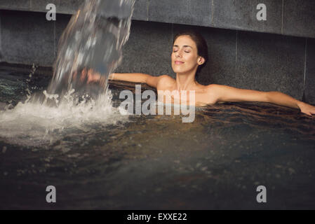 Woman soaking in spa pool Stock Photo