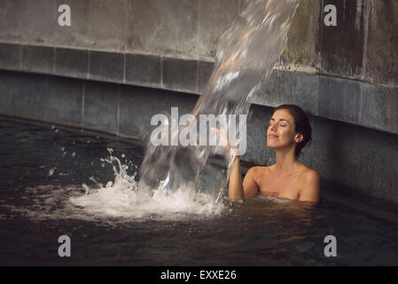 Woman soaking in spa pool Stock Photo