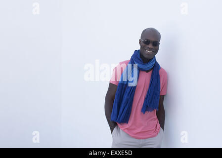Man wearing scarf and sunglasses, smiling, portrait Stock Photo