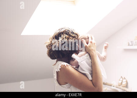 Mother holding baby, rear view Stock Photo