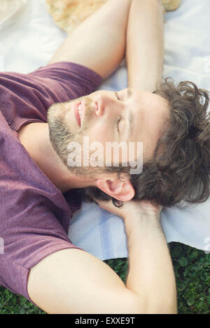 Man napping outdoors Stock Photo