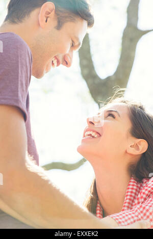 Couple laughing together outdoors Stock Photo