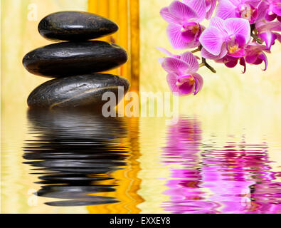 Japanese Zen garden with stacked stones mirroring in water Stock