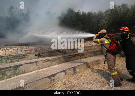 Athens, Greece. 17th July, 2015. Greek firemen try to extinguish flames burning on the mountain of Ymittos in Athens, Greece, July 17, 2015. One person has died as Greek firemen battled the first major wildfires of this summer on Friday in Athens suburbs, the southern Peloponnese peninsula, and central Greece, according to the Fire Brigade. Credit:  Marios Lolos/Xinhua/Alamy Live News Stock Photo