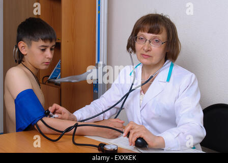 Family doctor examines a patient in the office Stock Photo