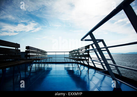 Wooden bench on top of the ferry boat with sea view Stock Photo