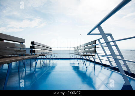 Wooden bench on top of the ferry boat with sea view Stock Photo