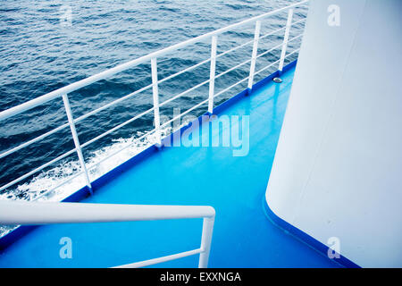 Blue turquoise floor with white fence on a ferry boat Stock Photo