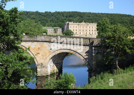 Chatsworh House from the arched bridge on the main approach to the Derbyshire stately home, Peak District,  England UK Stock Photo