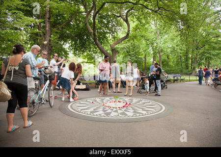 NEW YORK - May 25, 2015: People gather at Strawberry Fields in Central Park, New York City. Strawberry Fields is a memorial to h Stock Photo