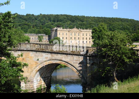 Chatsworh House from the arched bridge on the main approach to the Derbyshire stately home, Peak District,  England UK Stock Photo