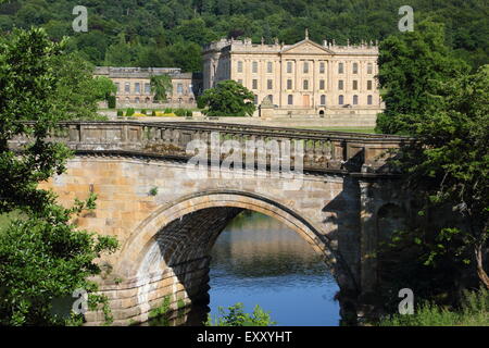 Chatsworh House from the arched bridge on the main approach to the Derbyshire stately home, Peak District,  England UK Stock Photo