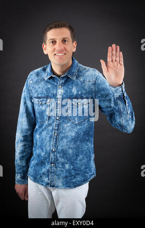 Handsome man doing different expressions in different sets of clothes: waving Stock Photo