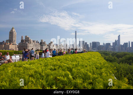 NEW YORK - May 26, 2015: Tourists enjoy the view of Manhattan from the Roof Garden Cafe and Martini Bar which is located at theM Stock Photo