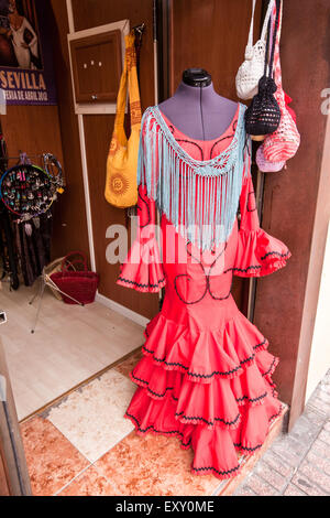 Shop selling Seville flamenco dresses at this shop popular with tourists in Seville, Andalucia, Spain, Europe. During April Feri Stock Photo