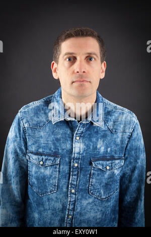 Handsome man doing different expressions in different sets of clothes: thinking Stock Photo