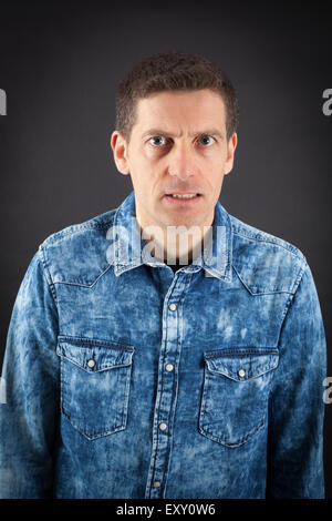 Handsome man doing different expressions in different sets of clothes: angry Stock Photo