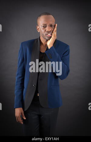 Handsome man doing different expressions in different sets of clothes: toothcahe Stock Photo