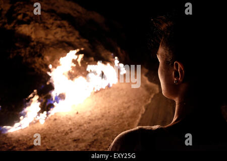 Natural gas erupting from the earth and burning in Yanar Dag also called the Burning Hill on a hillside in the Absheron Peninsula near the city of Baku capital of Azerbaijan Stock Photo