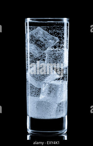 Glass with soda water and ice cubes. Stock Photo