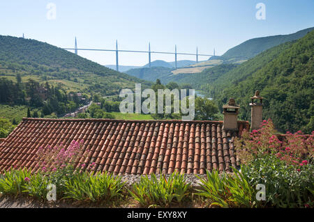 Millau viaduct and the river Tarn seen above pantiled roof from the village of Peyre, Aveyron,  Midi-Pyrénées, France , Europe Stock Photo