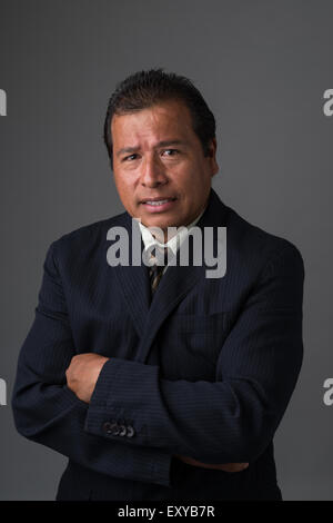 A Hispanic businessman in business suit looking concerned and worried. Stock Photo
