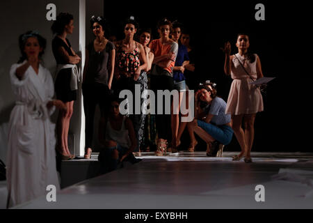 Models rehearse their catwalk on the runway before a fashion show Stock Photo