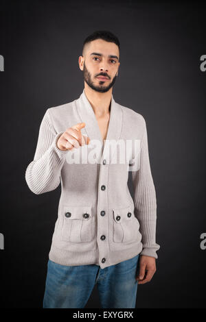 Handsome man doing different expressions in different sets of clothes: pointing Stock Photo