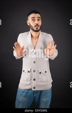 Handsome man doing different expressions in different sets of clothes: innocent Stock Photo