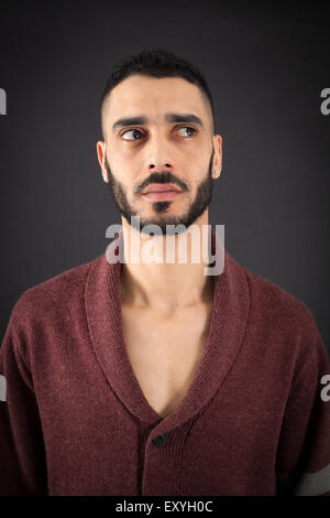 Handsome man doing different expressions in different sets of clothes: thinking Stock Photo