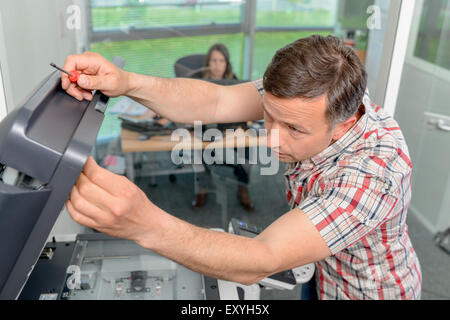 Trying to repair the office printer Stock Photo
