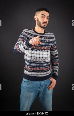 Handsome man doing different expressions in different sets of clothes: suspicion Stock Photo