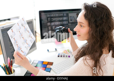 View of a Young woman photographer choosing pictures Stock Photo