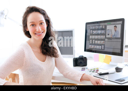 View of Young woman photographer working in her office Stock Photo