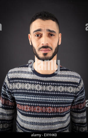 Handsome man doing different expressions in different sets of clothes: sad Stock Photo