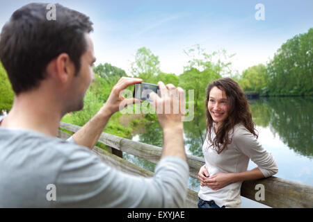 View of a Man taking pictures of his girlfriend Stock Photo